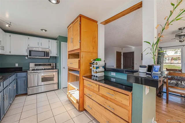 a kitchen with stainless steel appliances granite countertop a stove and a sink