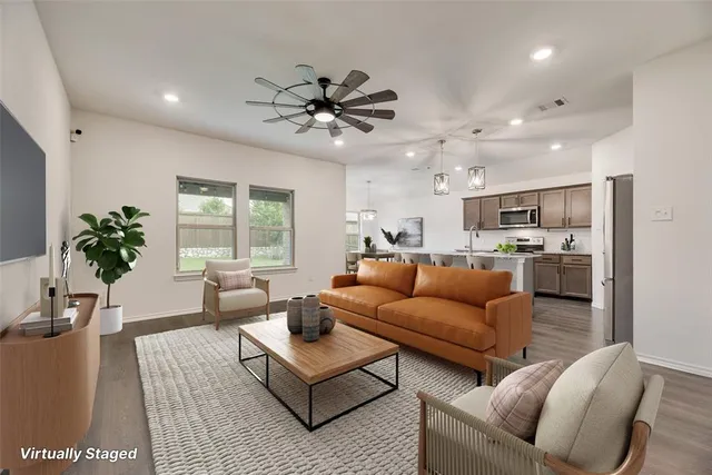 a view of a kitchen with a sink and stainless steel appliances