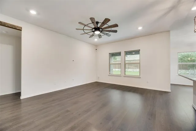 a living room with furniture kitchen and a large window