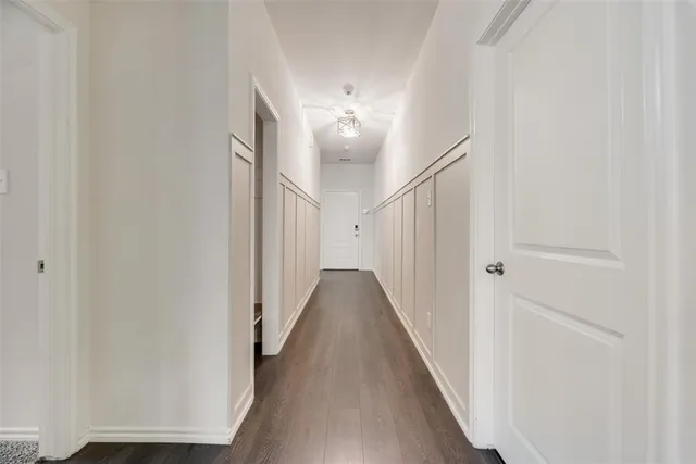 a view of an empty room with a chandelier fan