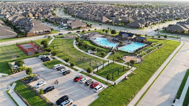 an aerial view of a house with a garden and swimming pool