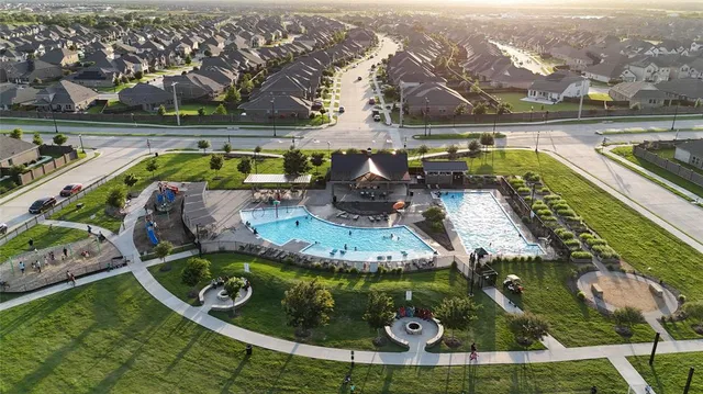 an aerial view of residential houses with outdoor space