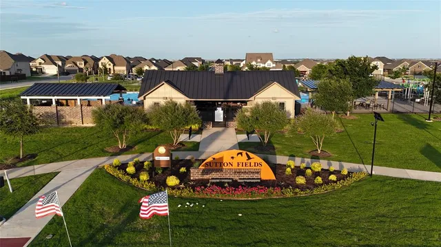 an aerial view of a house with garden space and a swimming pool