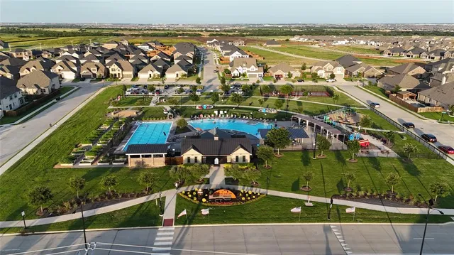 a aerial view of a house with swimming pool garden and patio