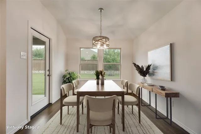 a very nice looking living room with a large window and kitchen view