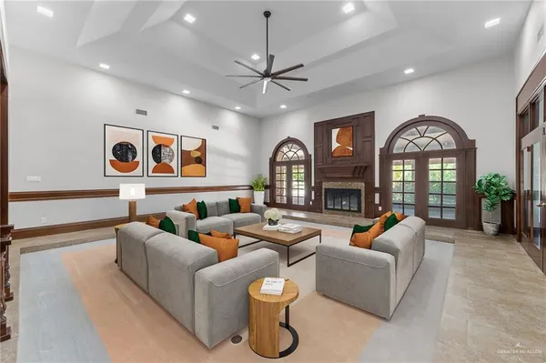 a living room with fireplace furniture and a large window