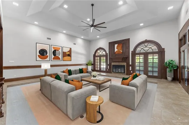 a living room with fireplace furniture and a large window