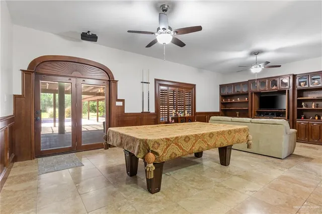 a living room with furniture a chandelier and a large window