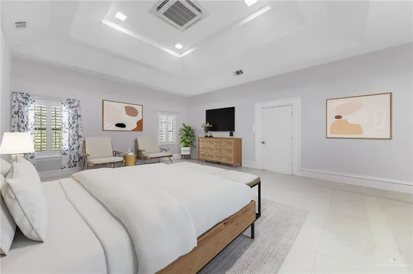 a bedroom with bed tv and window