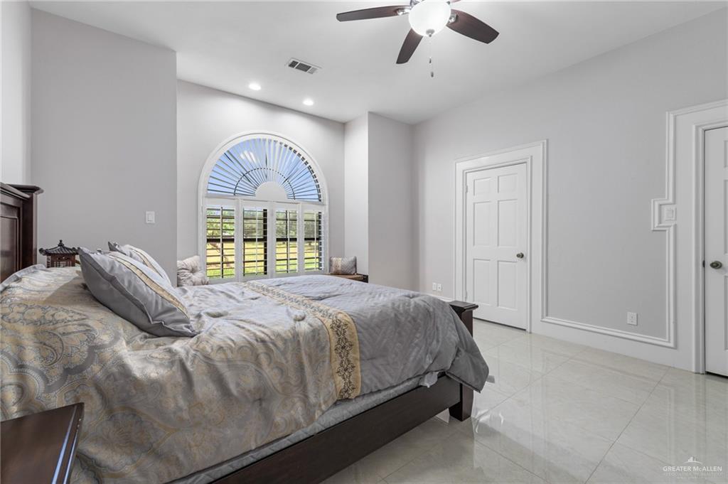 10409 North Ware Road McAllen, TX 78504 - Photo 20 of 45 a bedroom with a large bed and a large window