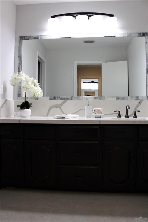 10409 North Ware Road McAllen, TX 78504 - Photo 24 of 45 a bathroom with a sink vanity and a mirror