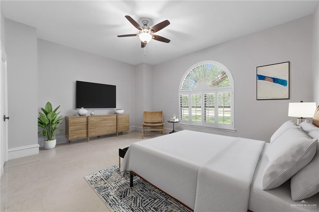 10409 North Ware Road McAllen, TX 78504 - Photo 26 of 45 a bedroom with a bed a window and a flat screen tv