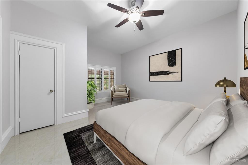10409 North Ware Road McAllen, TX 78504 - Photo 28 of 45 a bed room with a bed and a chandelier