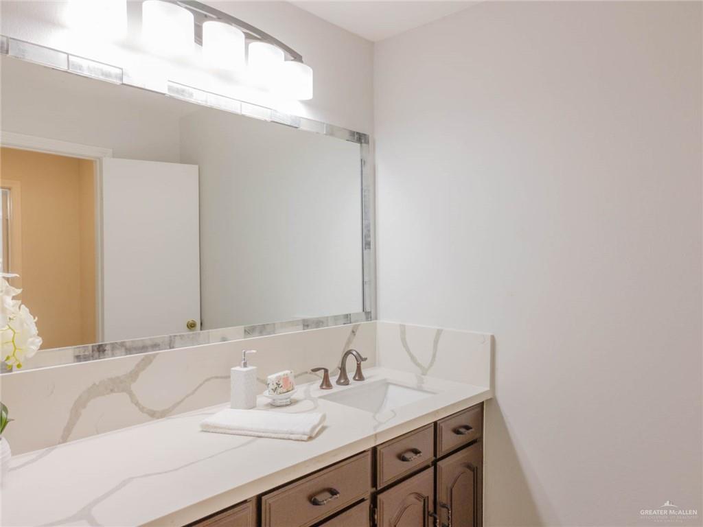 10409 North Ware Road McAllen, TX 78504 - Photo 31 of 45 a bathroom with a sink and a mirror