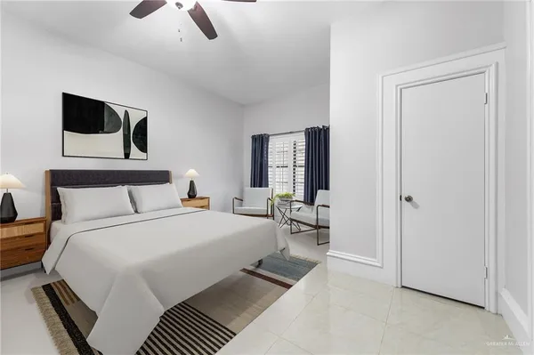 a bedroom with a bed a mirror and night stand