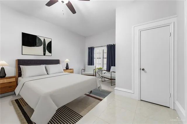 a bedroom with a bed a mirror and night stand