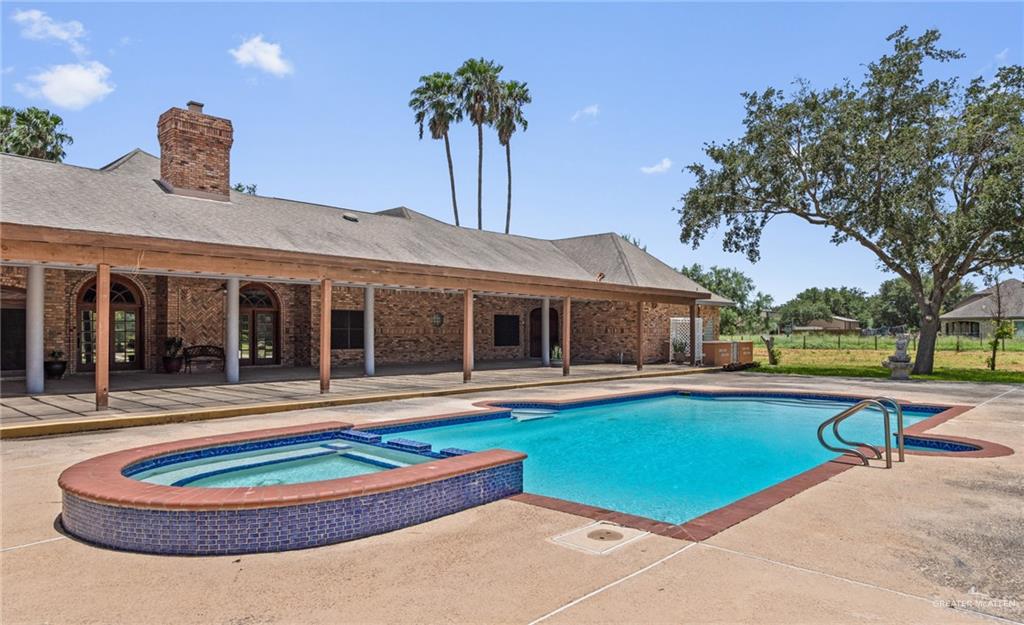 10409 North Ware Road McAllen, TX 78504 - Photo 39 of 45 a front view of a house with swimming pool and a yard