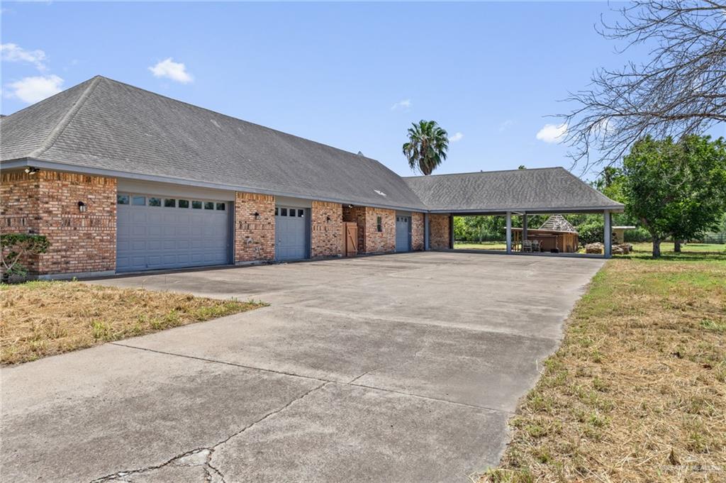 10409 North Ware Road McAllen, TX 78504 - Photo 42 of 45 a front view of a house with a yard and garage