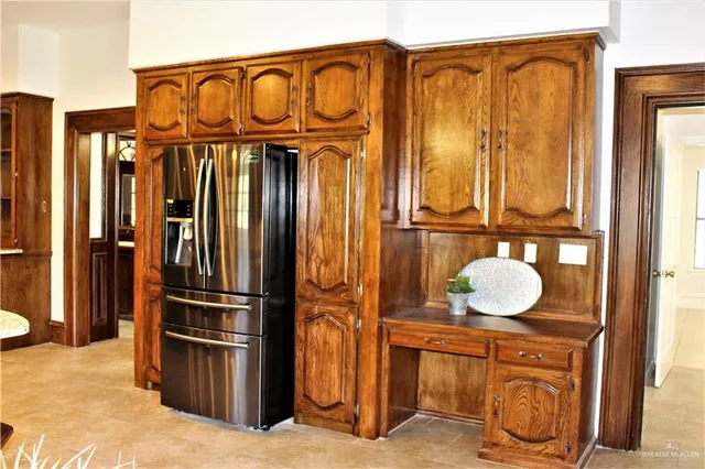 a kitchen with stainless steel appliances granite countertop a refrigerator and a stove top oven