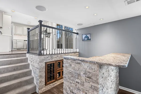 a open kitchen with kitchen island stainless steel appliances sink cabinets and fireplace
