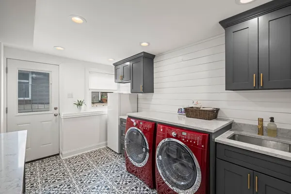 a utility room with sink dryer and washer