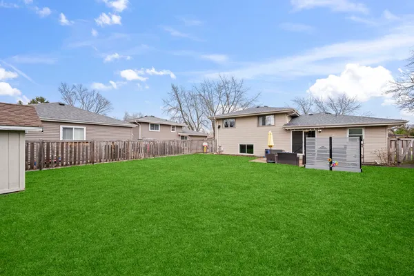 a view of a house with backyard and garden