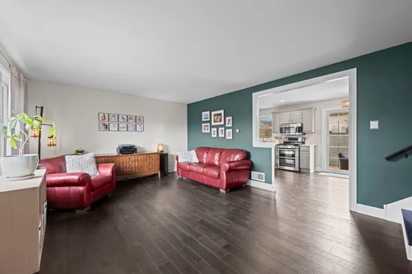 a bedroom with furniture and a wooden floor