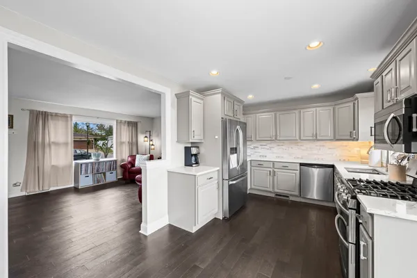 a kitchen with refrigerator and cabinets