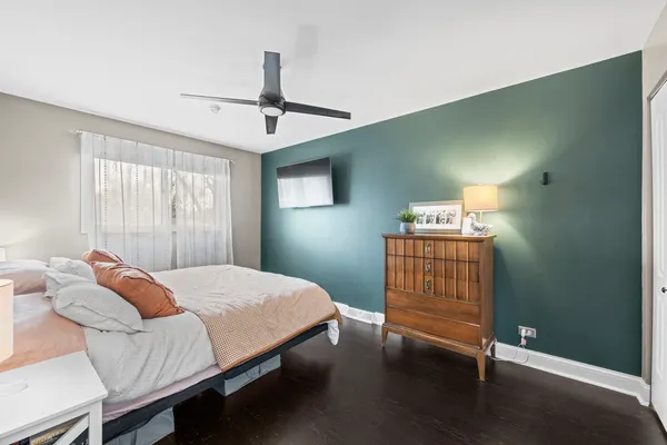 a bedroom with a bed window and a chandelier