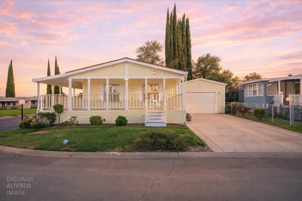 a front view of a house with a garden