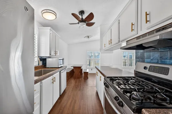 a kitchen with stove cabinets and a stove top oven