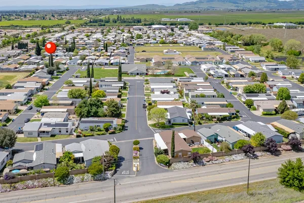 an aerial view of residential houses with outdoor space