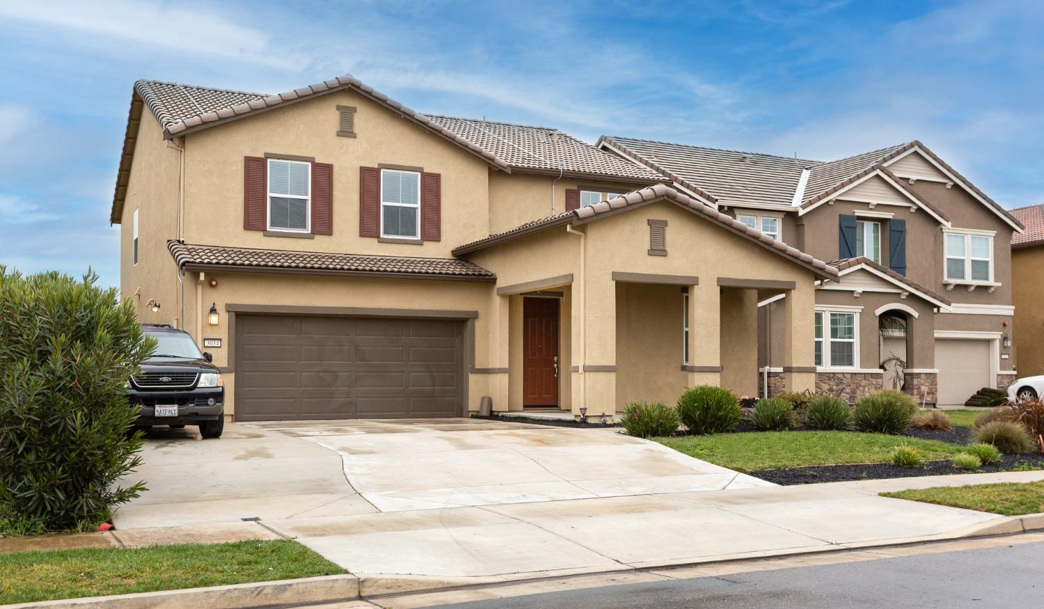 a front view of a house with a yard and garage