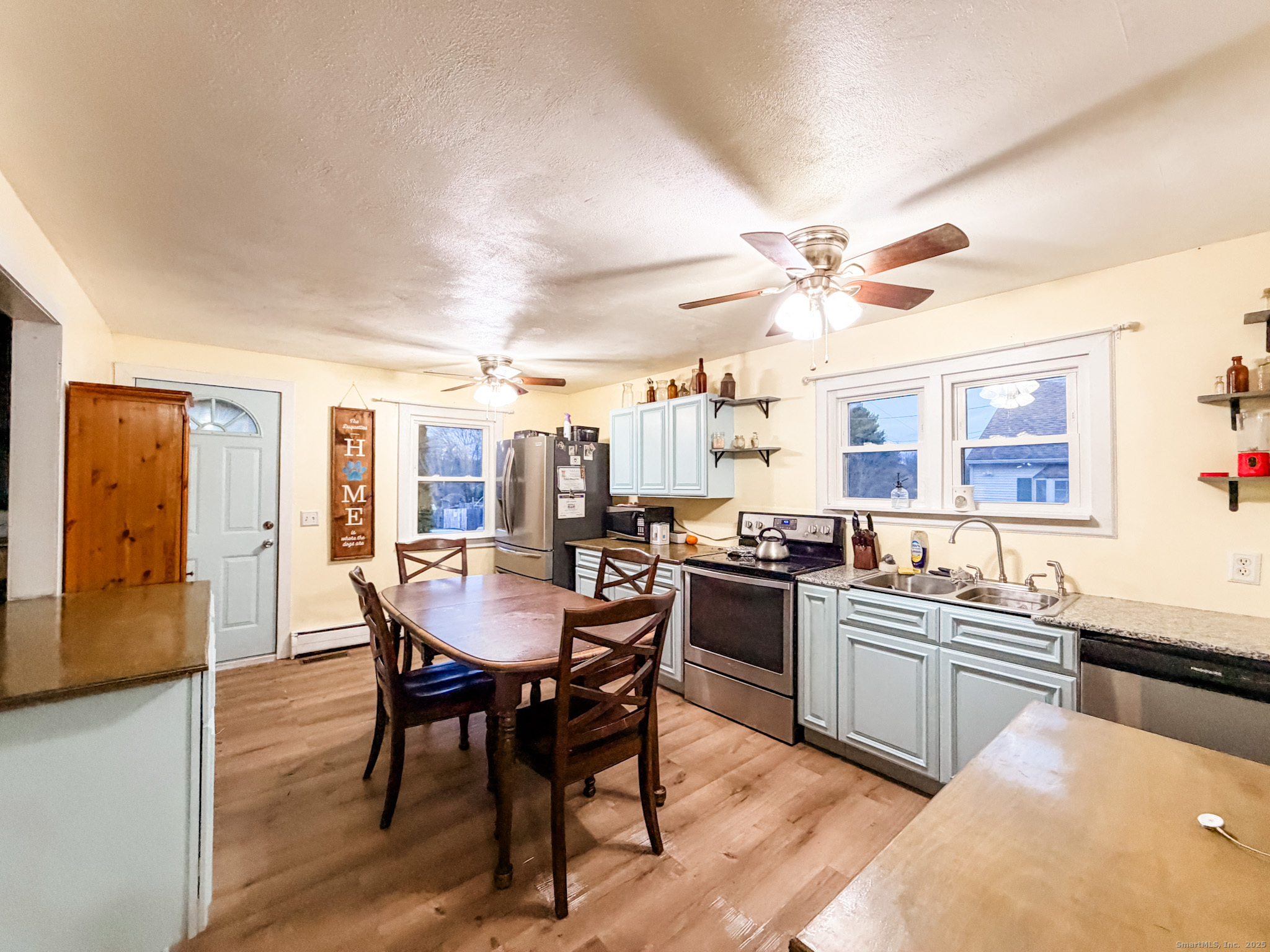 3 Ferland Drive Killingly, CT 06241 - Photo 2 of 19 a kitchen with a dining table chairs and stove