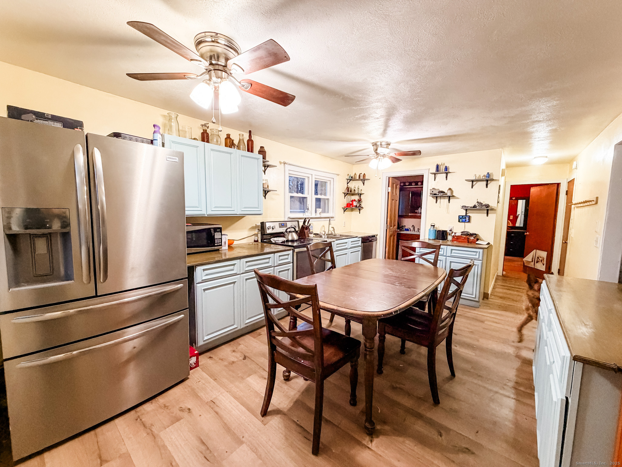 3 Ferland Drive Killingly, CT 06241 - Photo 5 of 19 a kitchen with stainless steel appliances a table chairs and a refrigerator