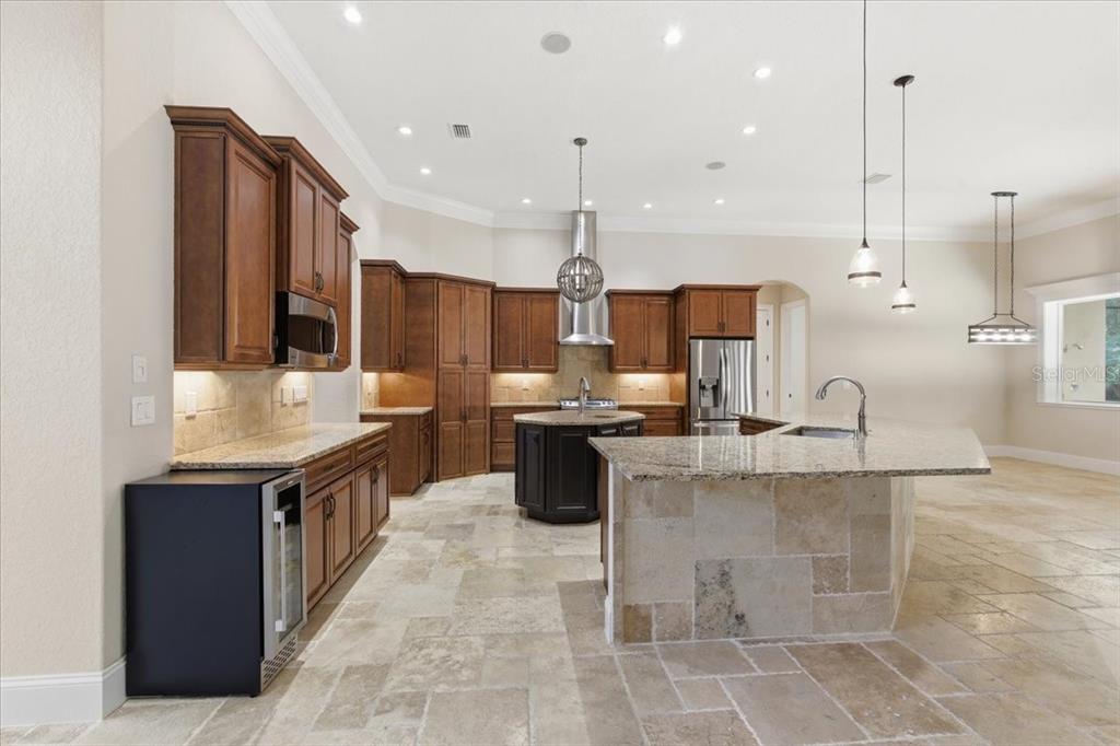 7 Spanish Moss Court Palm Coast, FL 32137 - Photo 13 of 66 a kitchen with stainless steel appliances granite countertop a stove a sink and a refrigerator