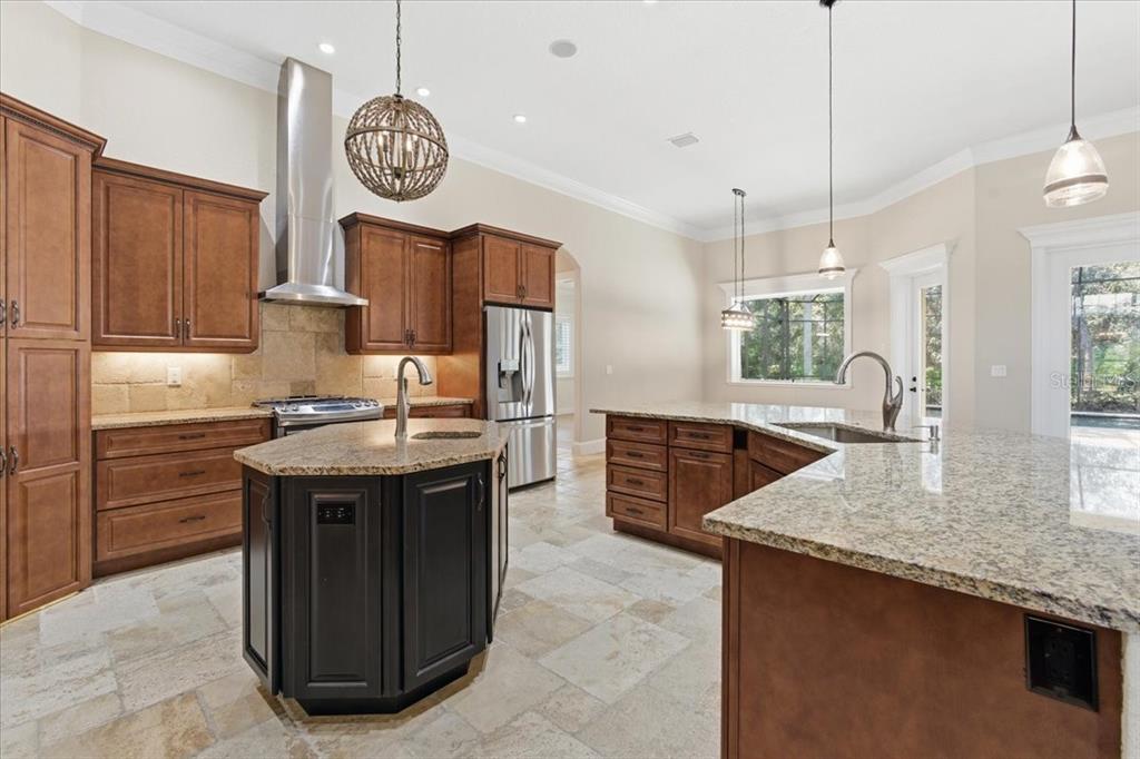 7 Spanish Moss Court Palm Coast, FL 32137 - Photo 15 of 66 a kitchen with granite countertop a sink a stove top oven a clock and cabinets
