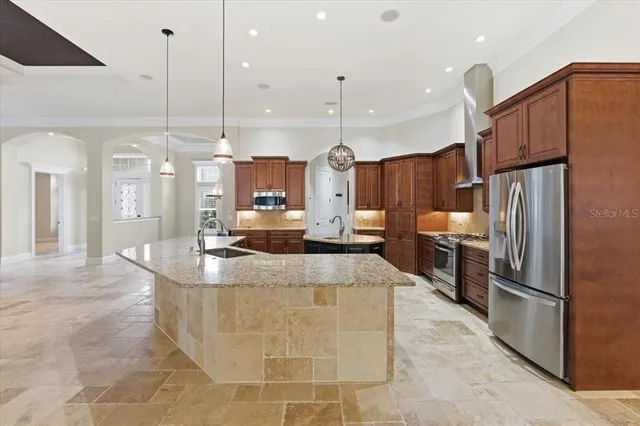 a view of an empty room with wooden floor and a ceiling fan