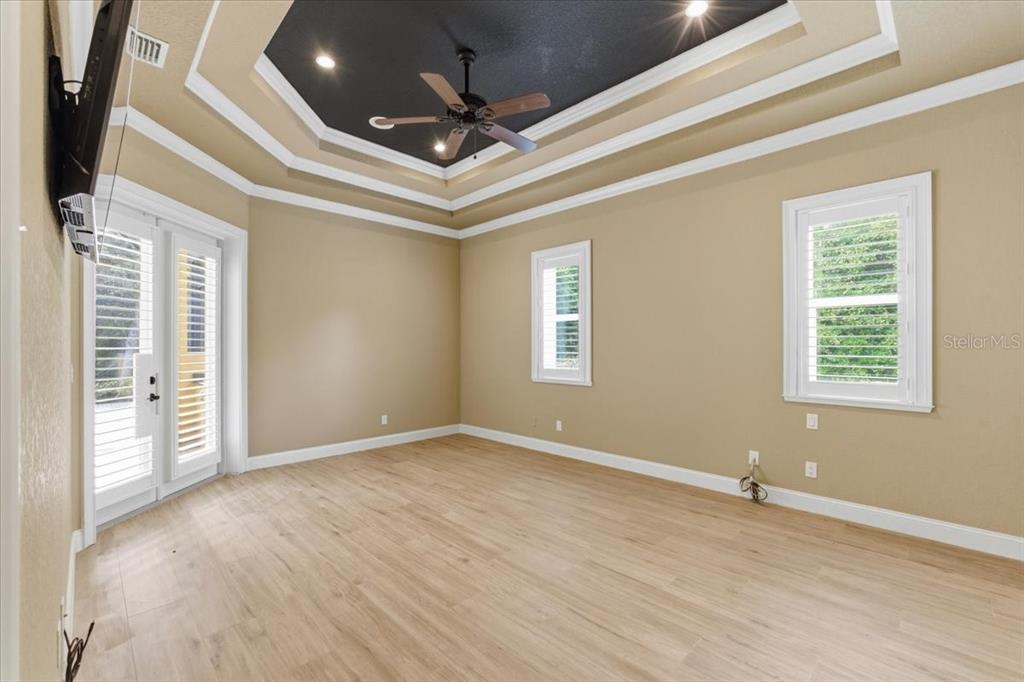 7 Spanish Moss Court Palm Coast, FL 32137 - Photo 22 of 66 an empty room with wooden floor and windows