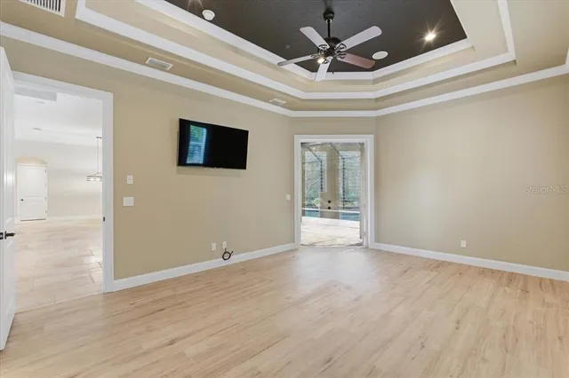a view of an empty room with cabinet and a window