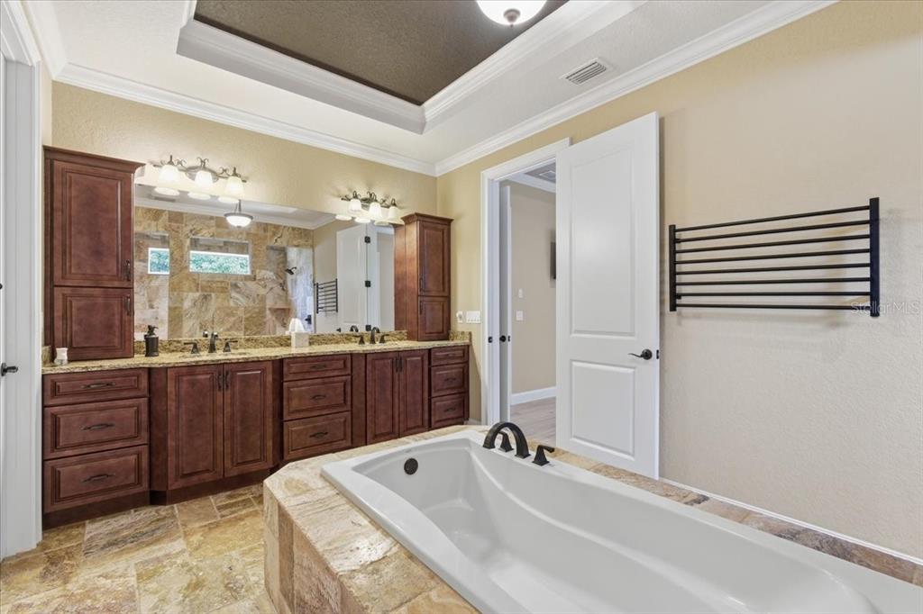 7 Spanish Moss Court Palm Coast, FL 32137 - Photo 25 of 66 a bathroom with a tub sink and mirror