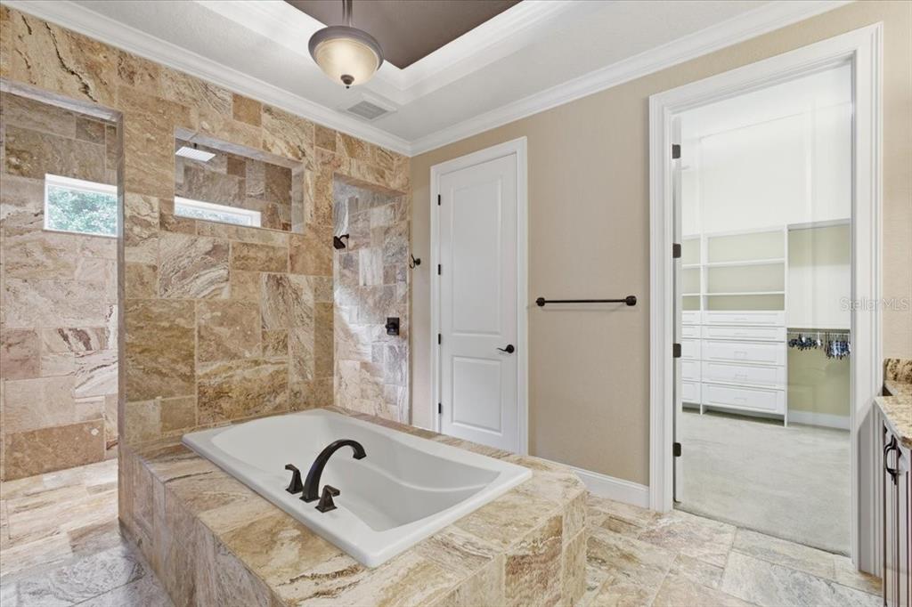 7 Spanish Moss Court Palm Coast, FL 32137 - Photo 26 of 66 a bathroom with a bathtub and shower