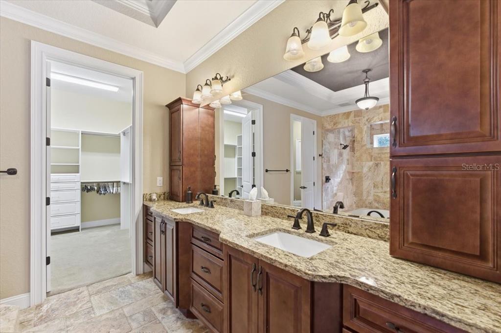 7 Spanish Moss Court Palm Coast, FL 32137 - Photo 31 of 66 a bathroom with a granite countertop double vanity sink and mirror