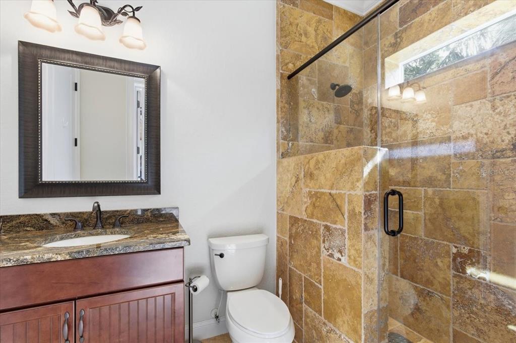 7 Spanish Moss Court Palm Coast, FL 32137 - Photo 40 of 66 a bathroom with a granite countertop sink toilet and shower