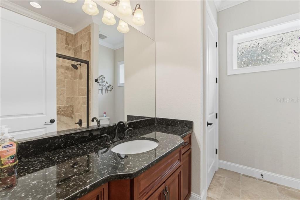 7 Spanish Moss Court Palm Coast, FL 32137 - Photo 45 of 66 a bathroom with a granite countertop sink and a mirror