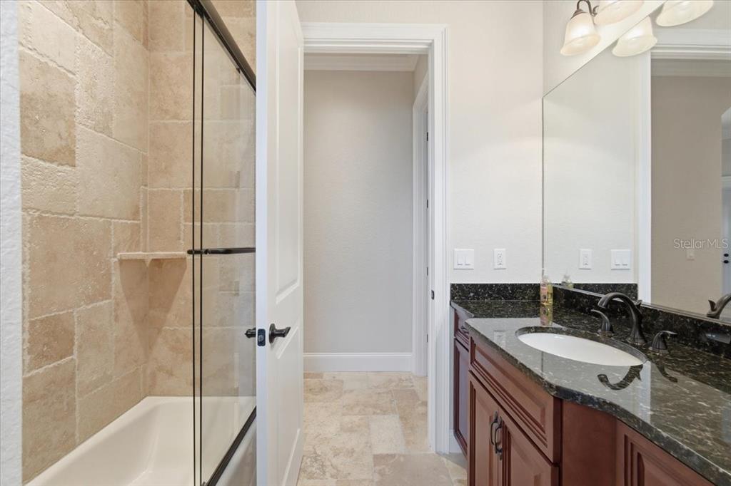 7 Spanish Moss Court Palm Coast, FL 32137 - Photo 46 of 66 a bathroom with a granite countertop sink a mirror and a bathtub
