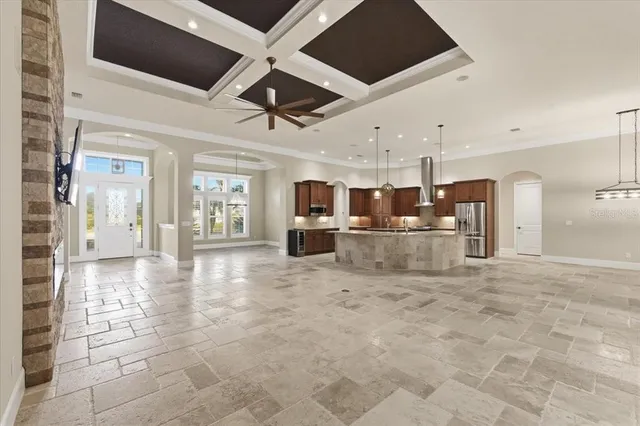 a kitchen with stainless steel appliances kitchen island granite countertop a refrigerator and a sink
