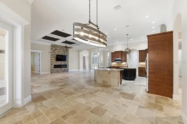 a large kitchen with kitchen island stainless steel appliances a stove a sink cabinets and a counter top