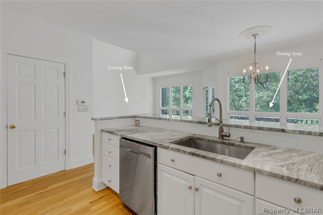 5818 Rivers Landing Terrace, Unit 5818 White Stone, VA 22578 - Photo 16 of 50 Kitchen featuring white cabinetry, sink, pendant lighting, light wood-type flooring, and stainless steel dishwasher