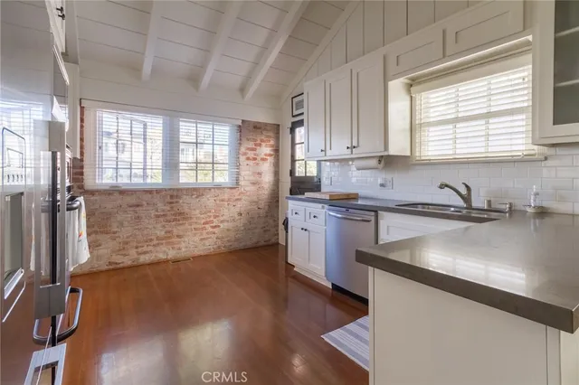 a kitchen with granite countertop a sink stove and cabinets